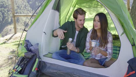 Happy-couple-having-rest-in-a-tent
