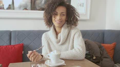 Portrait-of-beautiful-smiling-toothy-girl-having-a-relax-break-at-a-coffee-shop