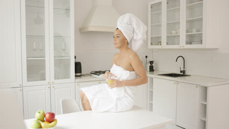 Female-wrapped-in-towel-sitting-on-table-