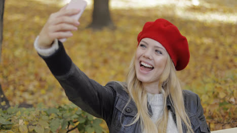 Happy-woman-taking-selfie-in-park