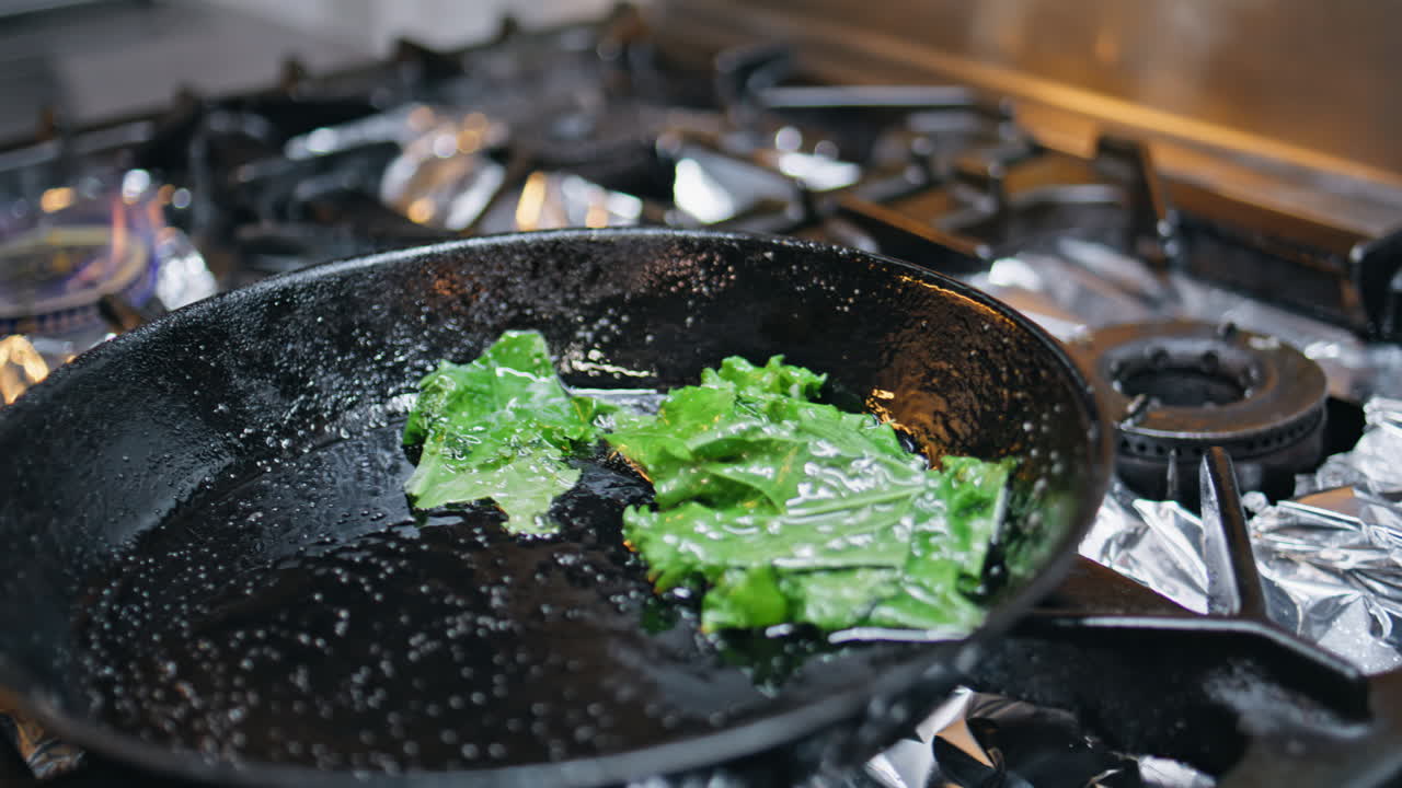 Chef flipping pan kitchen stove frying dish ingredients at workspace closeup