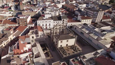 Aerial-view-circling-above-Roman-temple-of-Diana,-Spanish-city-of-Merida-landmark-marble-ruins