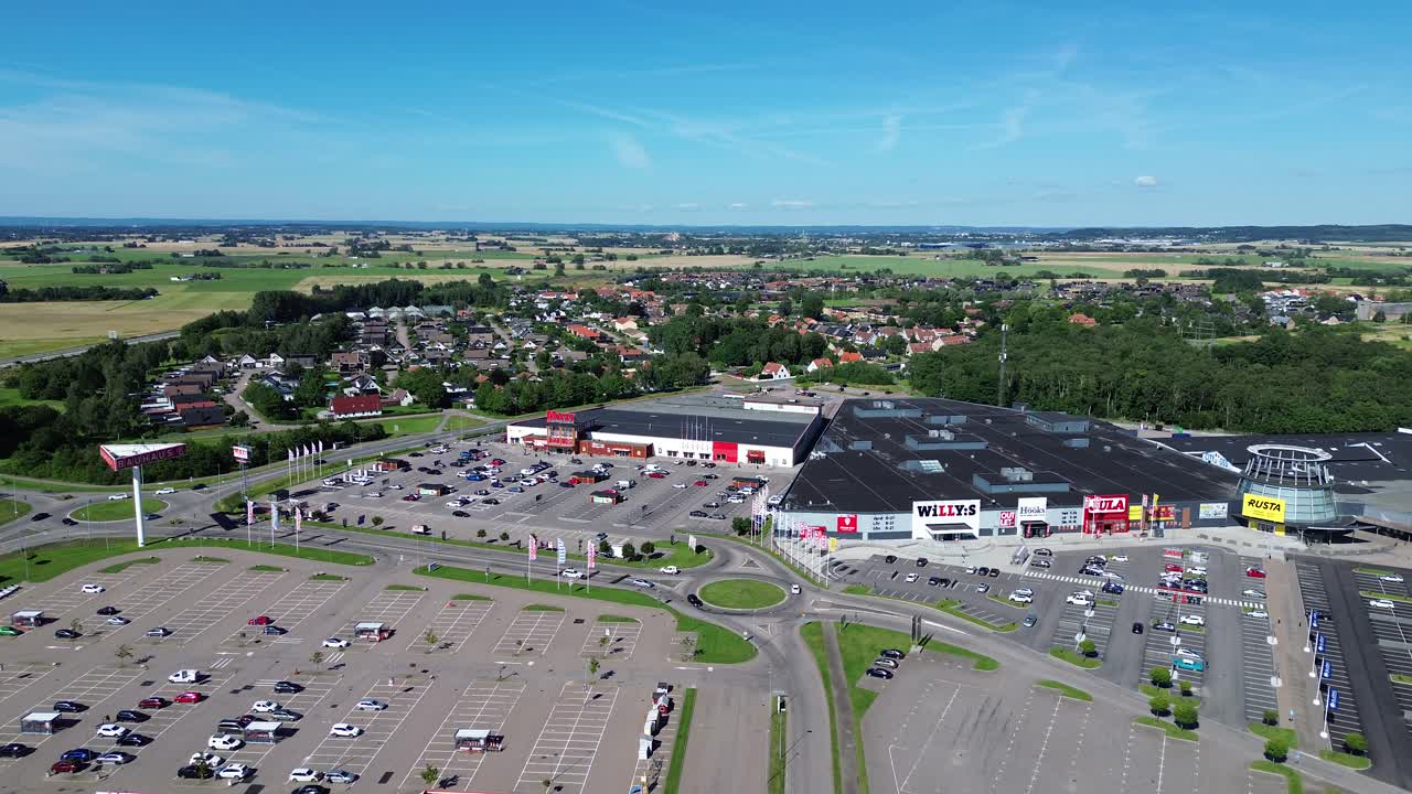 Hyllinge, Sweden: drone zooming out of a big shopping mall in the town of Hyllinge, Sweden