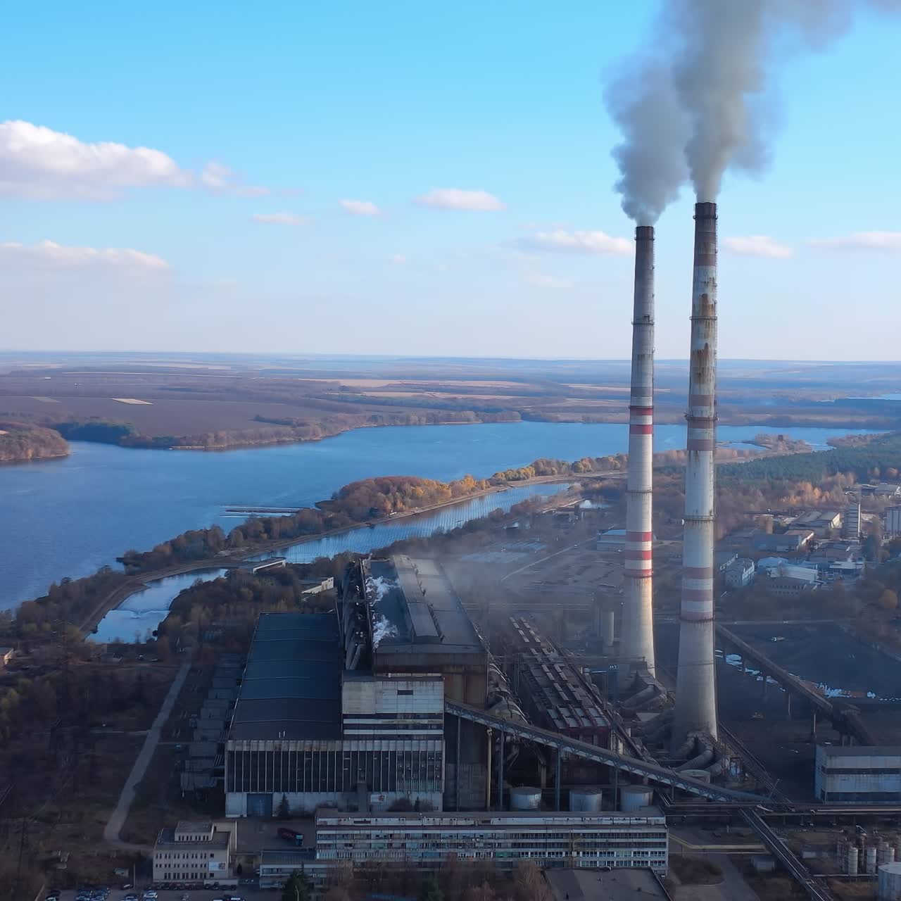 Atmospheric air pollution from industrial smoke. Pipes with chemical smoke from industrial plant. Thick smoke and steam pollute the environment. Climate change and global warming