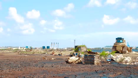 lanscape of barrels with crude oil and water tanks lying on asphalt lake