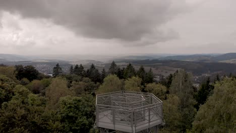 aerial view of the sauerland region in germany revealing the steel construction lookout point on top of the wilzenberg catholic pilgrimage mountain