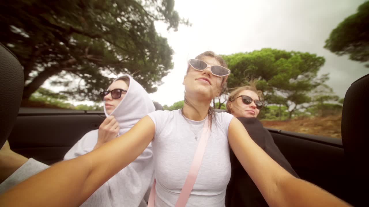 Friends on a road trip in a convertible