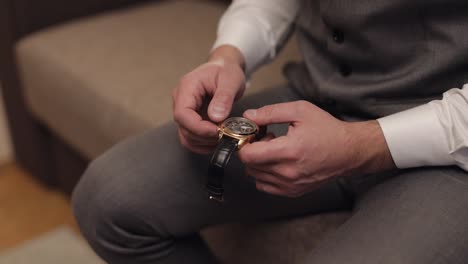 man wearing a gold watch