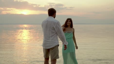 couple dancing at sunset on the beach