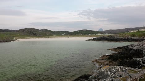 Coastal shot of toruists enjoying the white sands of Achmelvich Beach