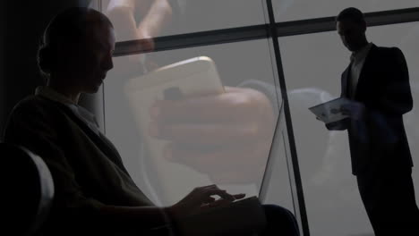 working on laptops and tablets, silhouetted people engaged in smartphone animation