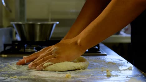 Chef-kneading-dough-in-kitchen-at-restaurant-4k