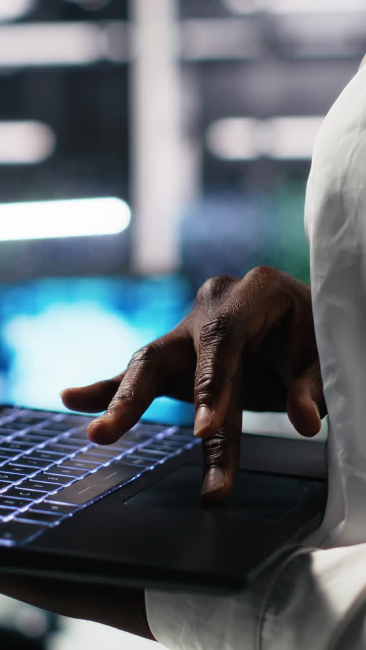 Vertical video Close up of data center technician using tablet to monitor neural network AI LLM