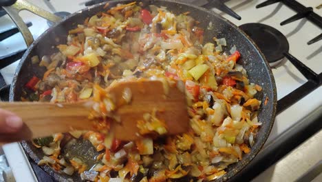 the cook cooks a stew in a frying pan