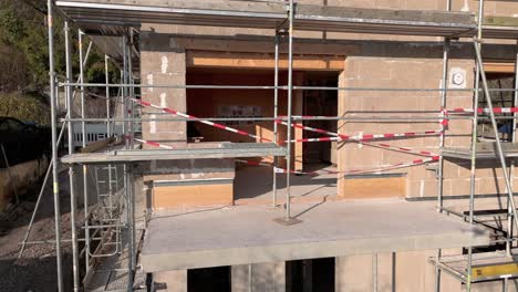 Aerial-corner-view-of-Hempcrete-house-during-construction-site,-slowly-panning-around-the-corner