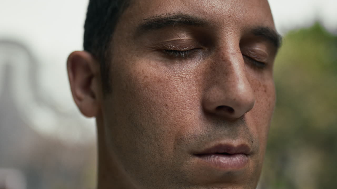 Close-up Portrait of a Man Meditating with Eyes Closed