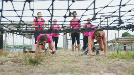 Female-friends-enjoying-exercising-at-boot-camp-together