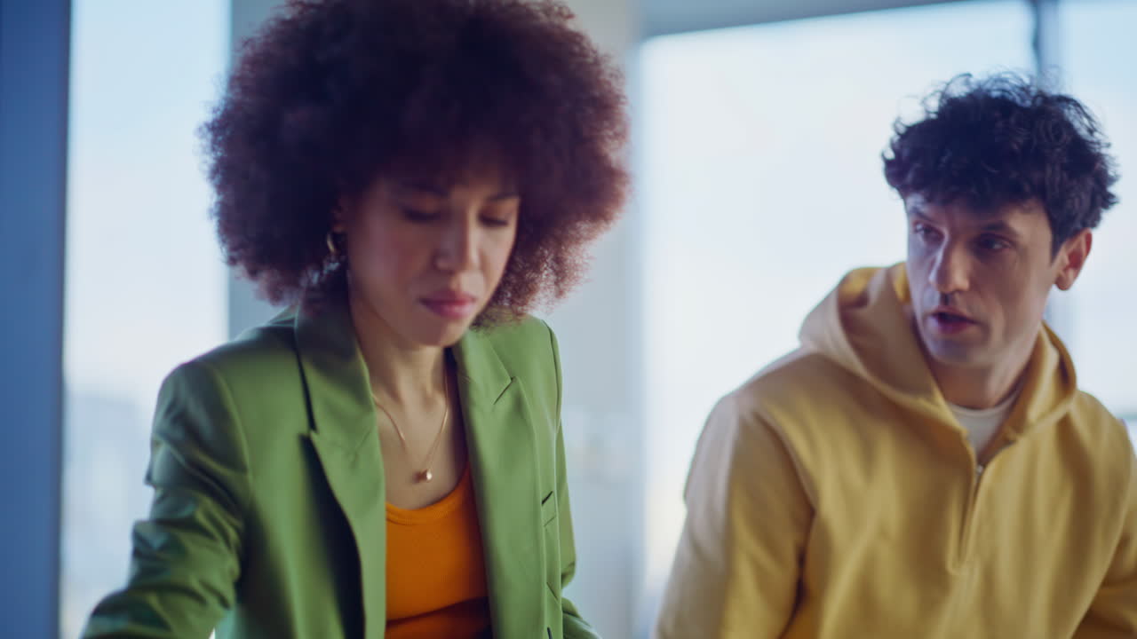Art director working design clothing with man stylist in creative office closeup