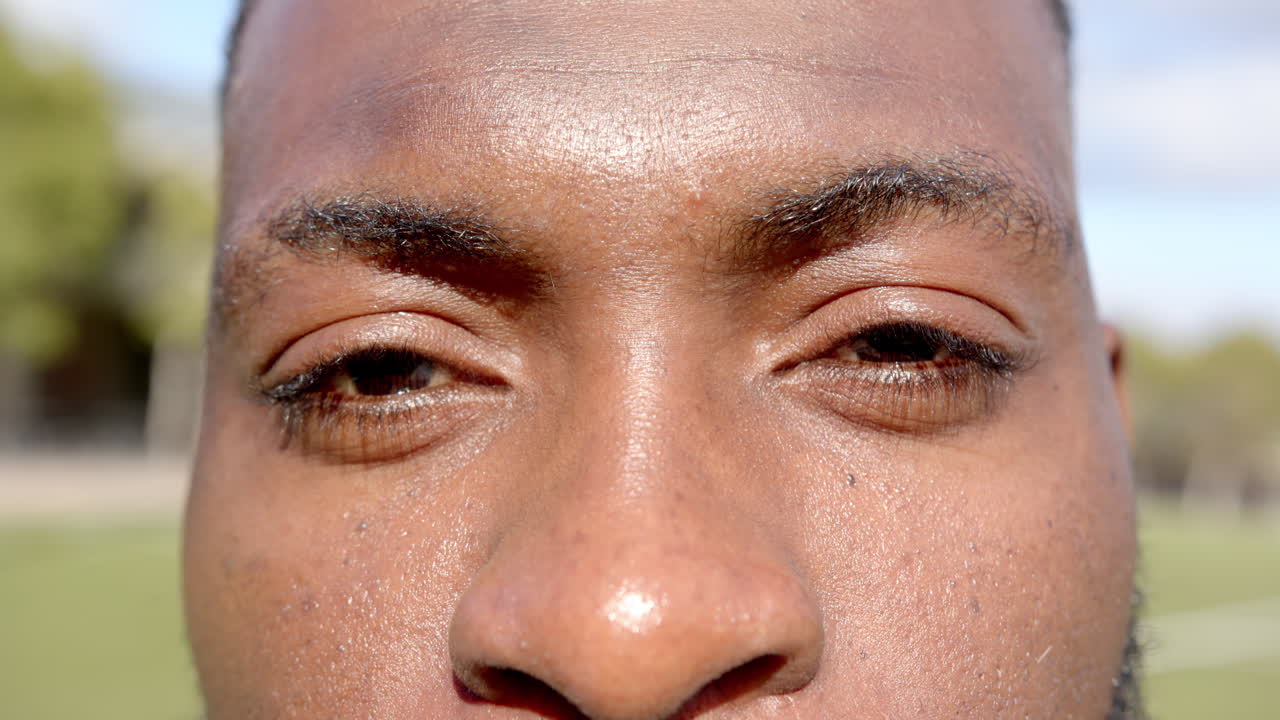Close-up of man's eyes and nose, focusing on intense expression on field