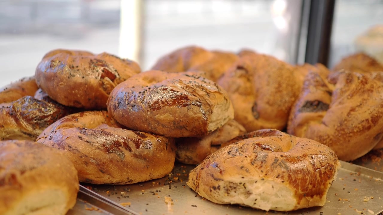 Freshly Baked Bagels Displayed on a Tray in a Bakery