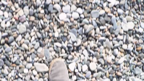 person walking on a rocky beach