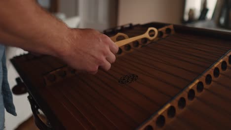 skilled professional musician hammering fast dulcimer string playing scale and chords