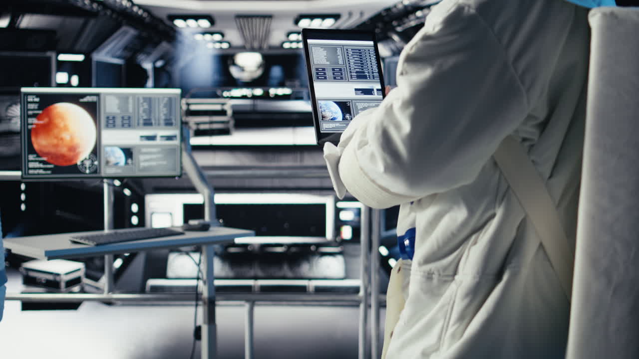 Close up of astronaut using tablet to check Mars telemetry data