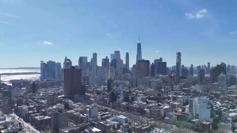 horizontal drone side-tracking shot over broome avenue in new york, showcasing the city's vibrant streets and historic buildings with the stunning new york skyline in the background.