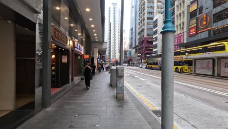 pedestrians walking along a bustling city street