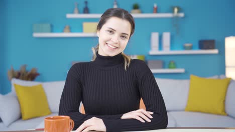 Portrait-of-happy-young-entrepreneur-woman-working-in-her-home-office.