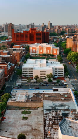 diverse blocks of flats in the cityscape of new york. drone footage above the roofs at sunset. vertical video
