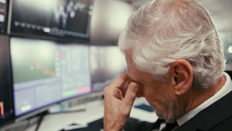 a businessman looking at stock market charts with concern