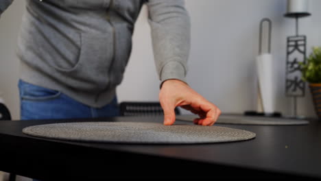 cropped view of a man cleaning table after dinner