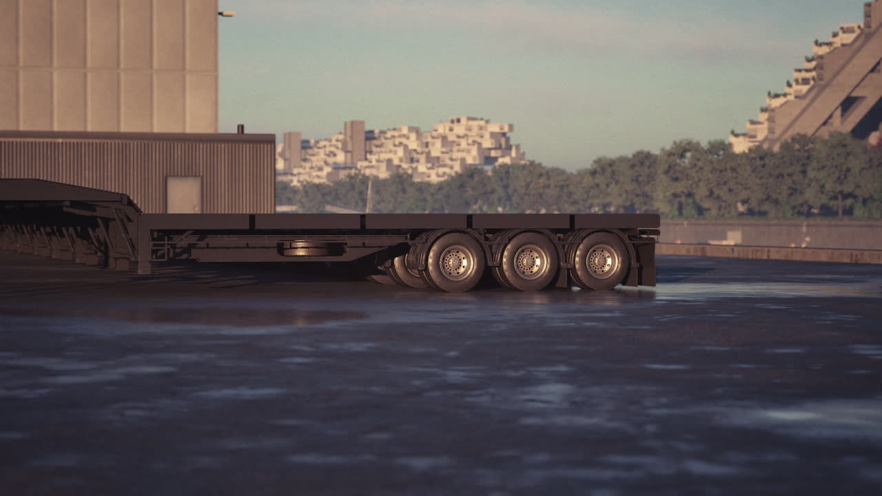 Heavy duty truck trailer parked near urban waterfront at sunset