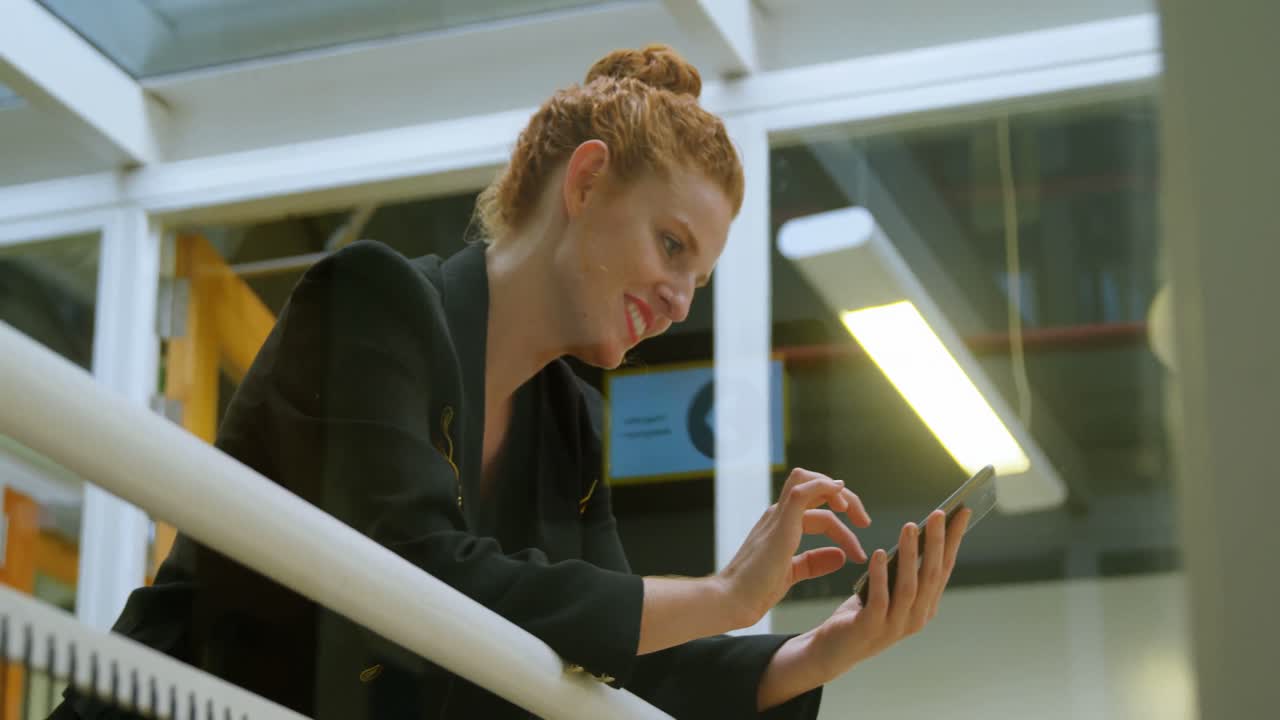 Businesswoman using mobile phone in office 4k