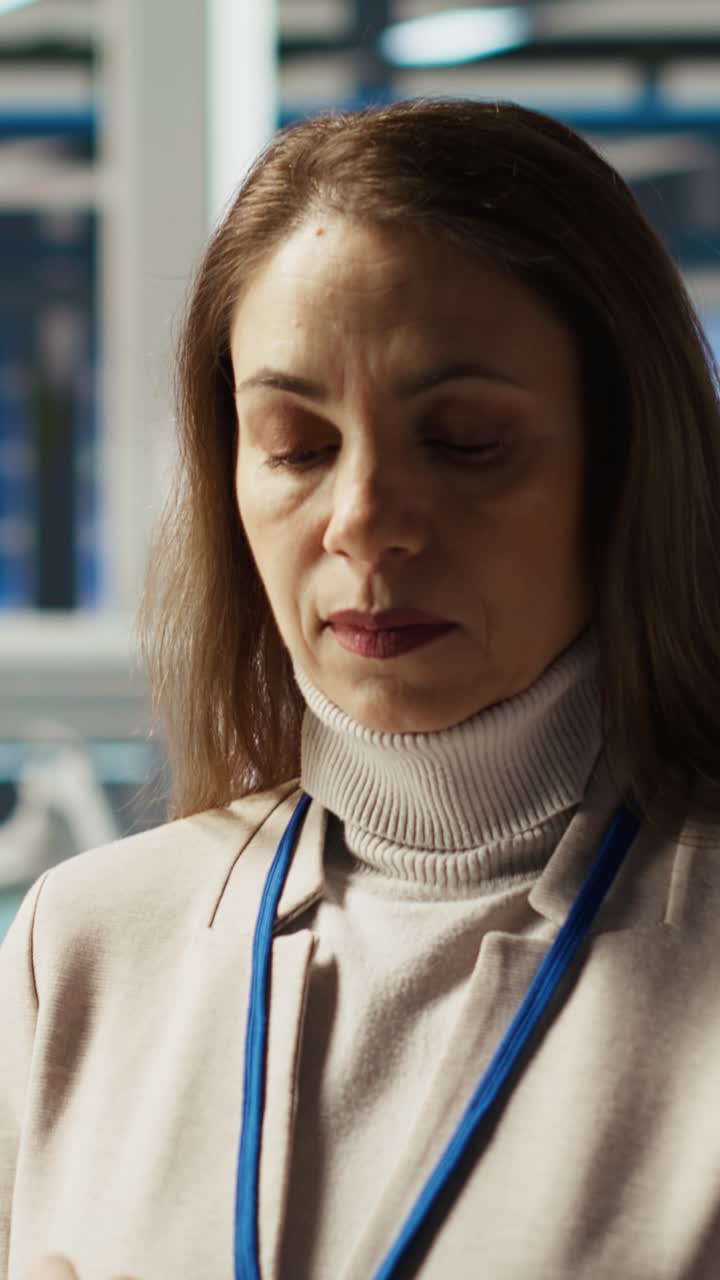 Vertical video Jolly researcher analyzes solar cell prototypes using tablet