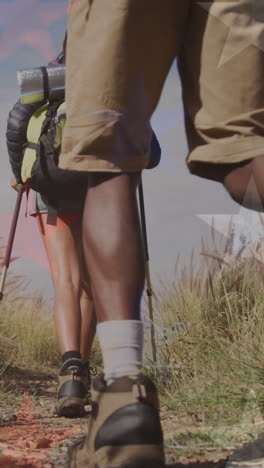 animation of flag of united states of america over people hiking in mountains