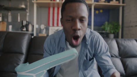 man celebrating while watching a video call or game