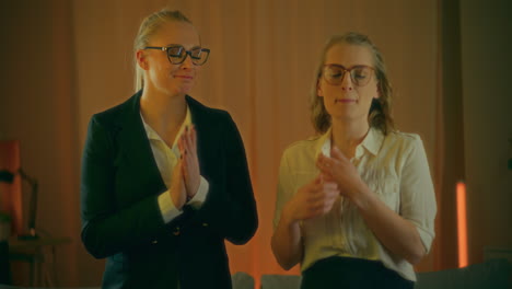 two women celebrate success during evening at home