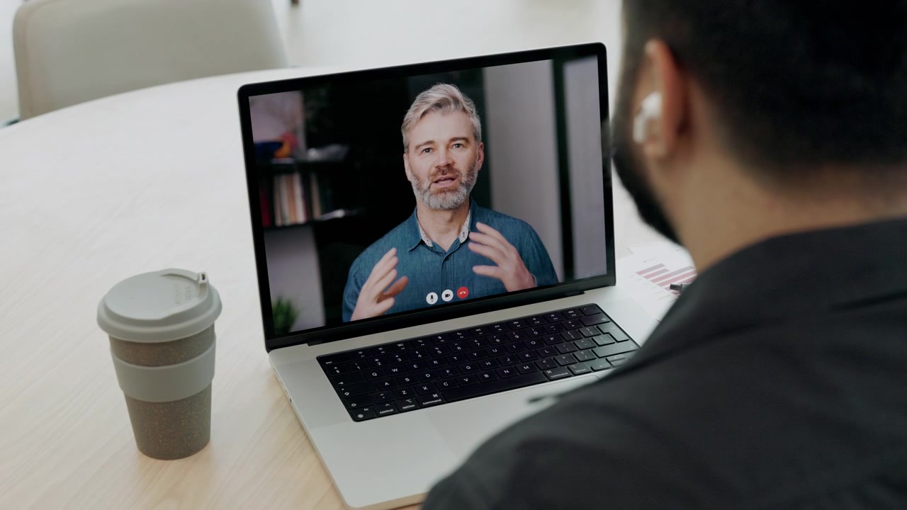 Man Participating in a Video Conference Call on Laptop