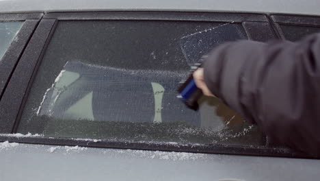 scraping ice off tinted car window