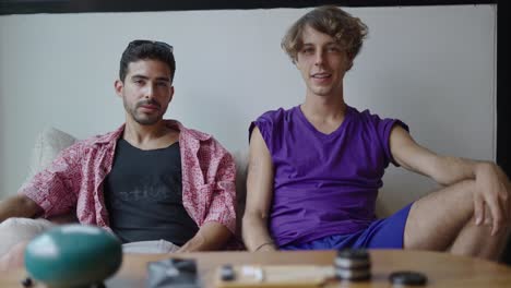 two young men relaxing on a couch