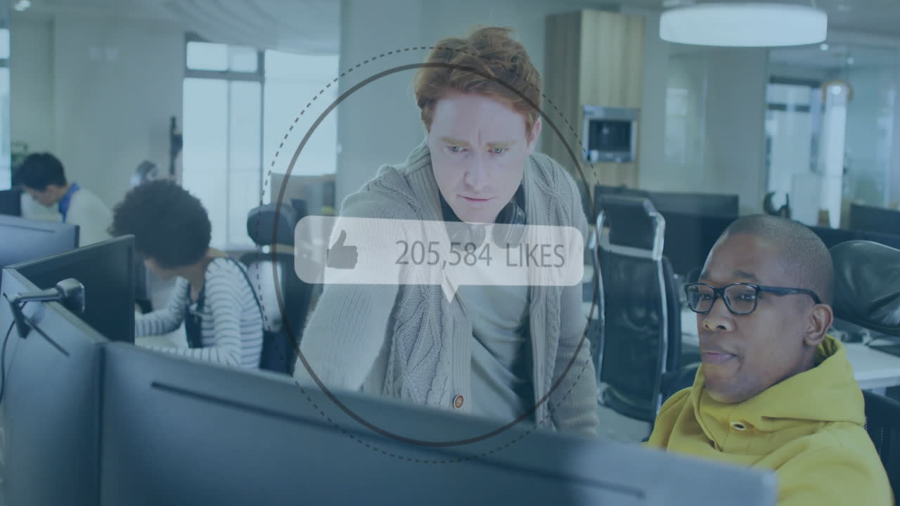 Two people working at computers with social media likes animation overlay