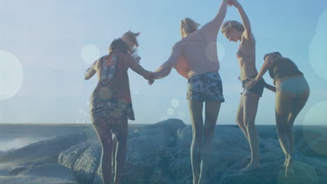 holding hands and jumping on rocks, friends enjoying beach day with bokeh animation