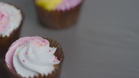 high angle close up shot of rotating cupcakes