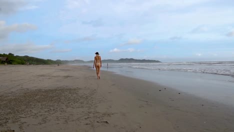 back view of a girl walking on a beach in costa rica