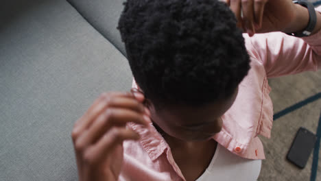 primer plano de una mujer afroamericana acostada en el sofá en casa