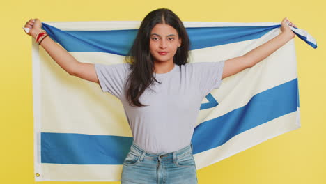 Indian-smiling-young-woman-holding-Israel-national-flag,-showing-victory-peace-sign-against-war