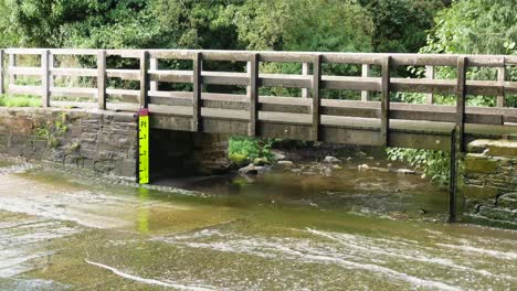 wide shot of multiple cars splashing through a ford