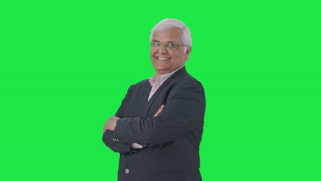 Portrait-of-Happy-Indian-senior-businessman-standing-crossed-hands-Green-screen